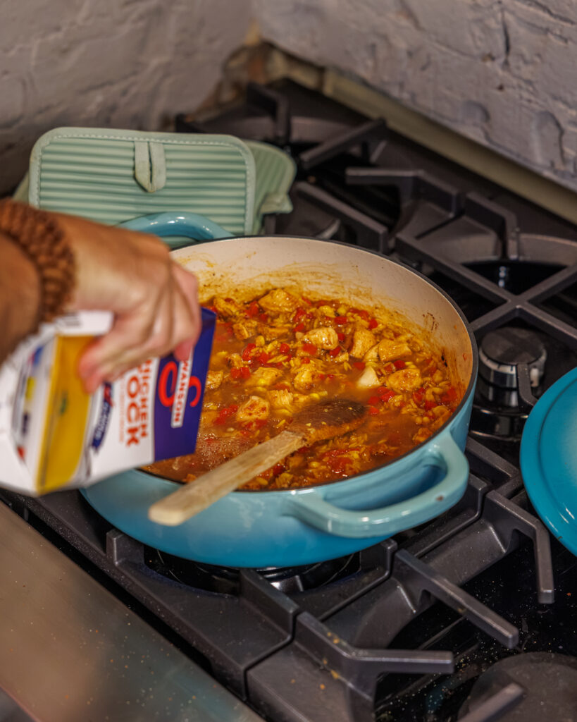 Matthew Bounds, creator of Your Barefoot Neighbor, add ingredients to his One Pot Corn & Pimento Orzo
