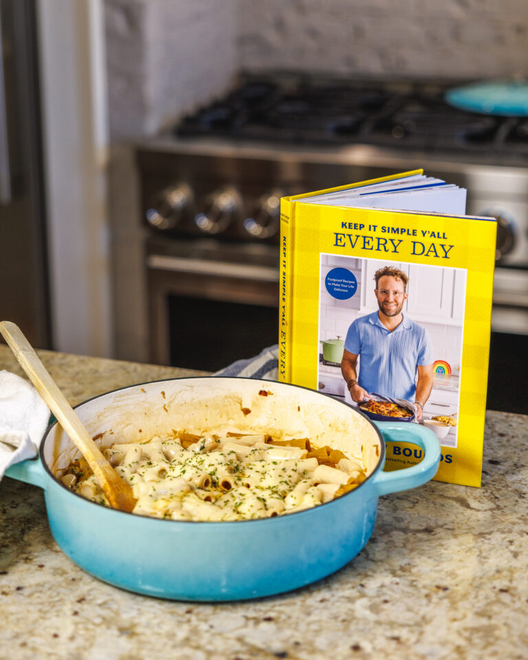 The book Keep It Simple Y'all Every Day is on a counter next to a bowl of One Pot French Onion Pasta created by Matthew Bounds, creator of Your Barefoot Neighbor