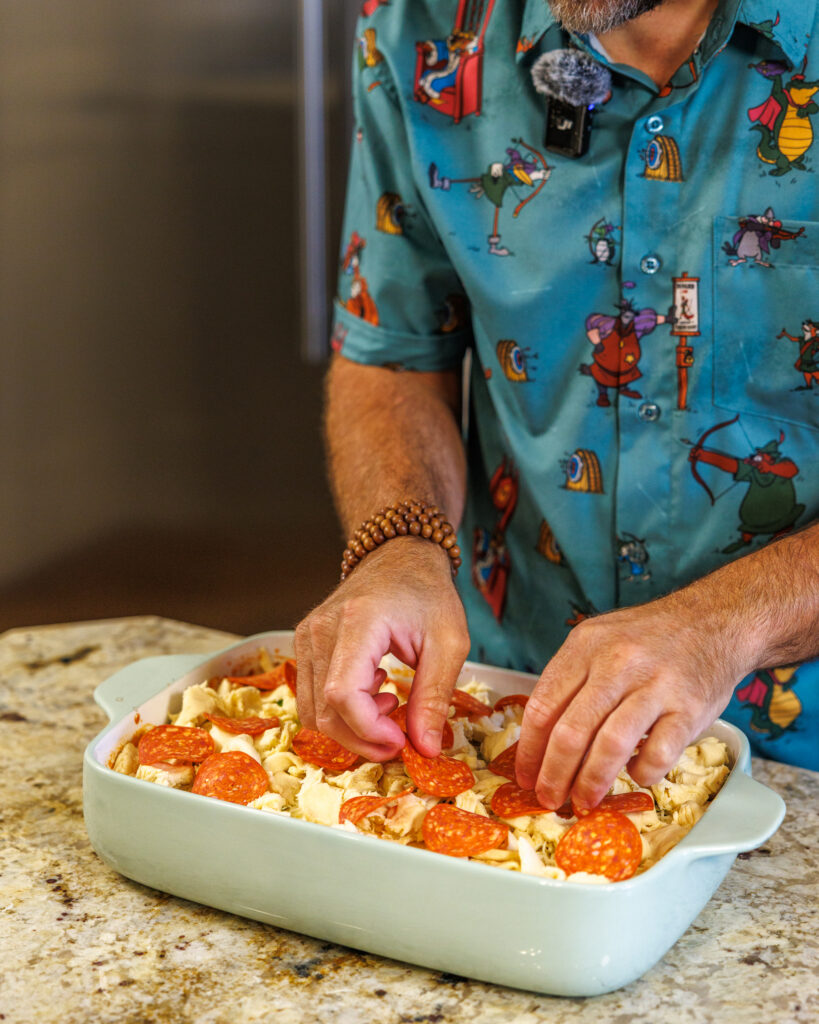 Matthew Bounds, creator of Your Barefoot Neighbor, adds ingredients to his Pizza Bubble Bake dish
