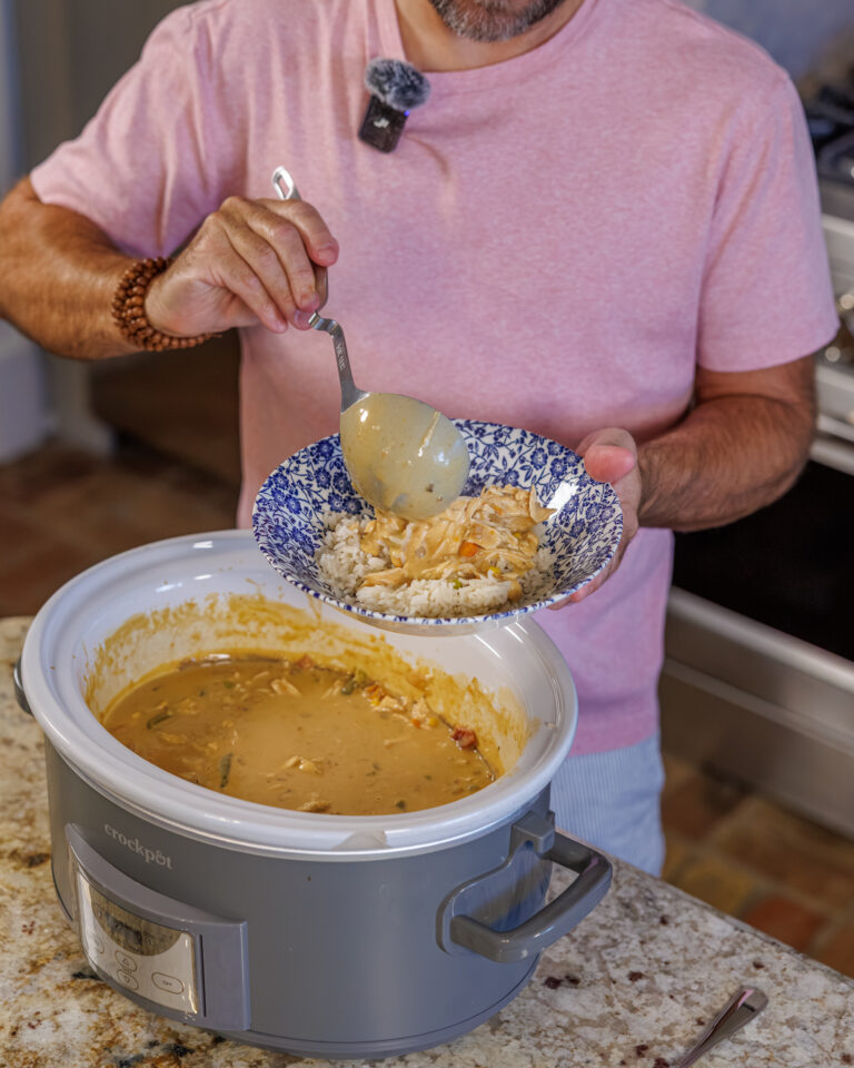 Matthew Bounds, creator of Your Barefoot Neighbor, spoons a helping of Slow Cooker Chicken & Gravy into a bowl