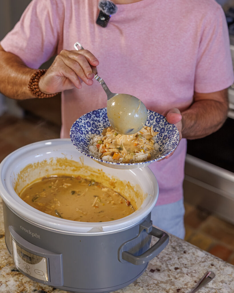 Matthew Bounds, creator of Your Barefoot Neighbor, spoons a helping of Slow Cooker Chicken & Gravy into a bowl