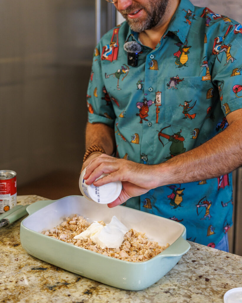 Matthew Bounds, creator of Your Barefoot Neighbor, adds ingredients to a 9x13 dish for his Tater Tot Chicken Casserole
