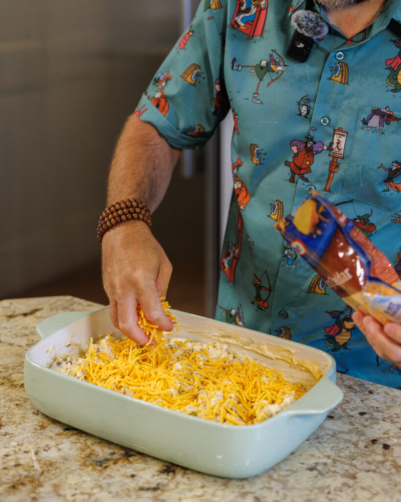 Matthew Bounds, creator of Your Barefoot Neighbor, adds ingredients to a 9x13 dish for his Tater Tot Chicken Casserole