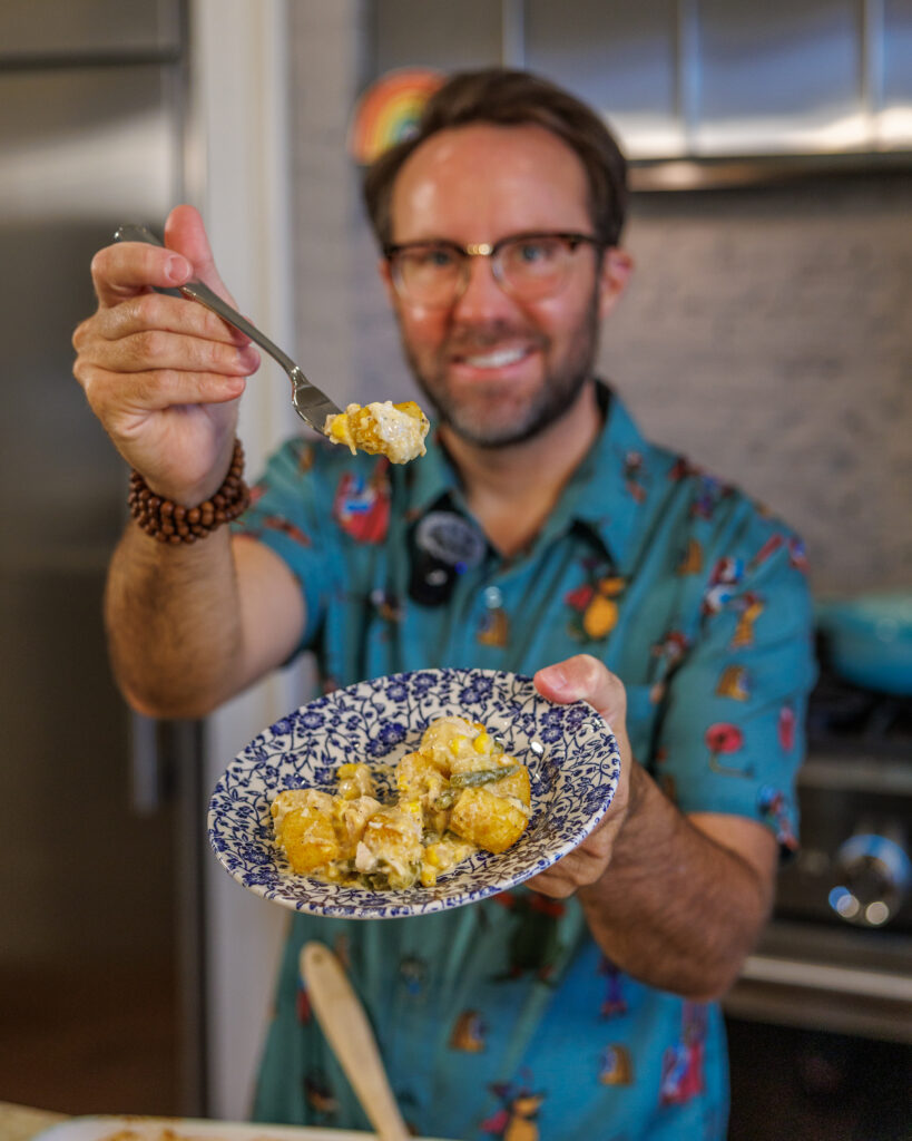 Matthew Bounds, creator of Your Barefoot Neighbor, holds a spoonful of his Tator Tot Chicken Casserole