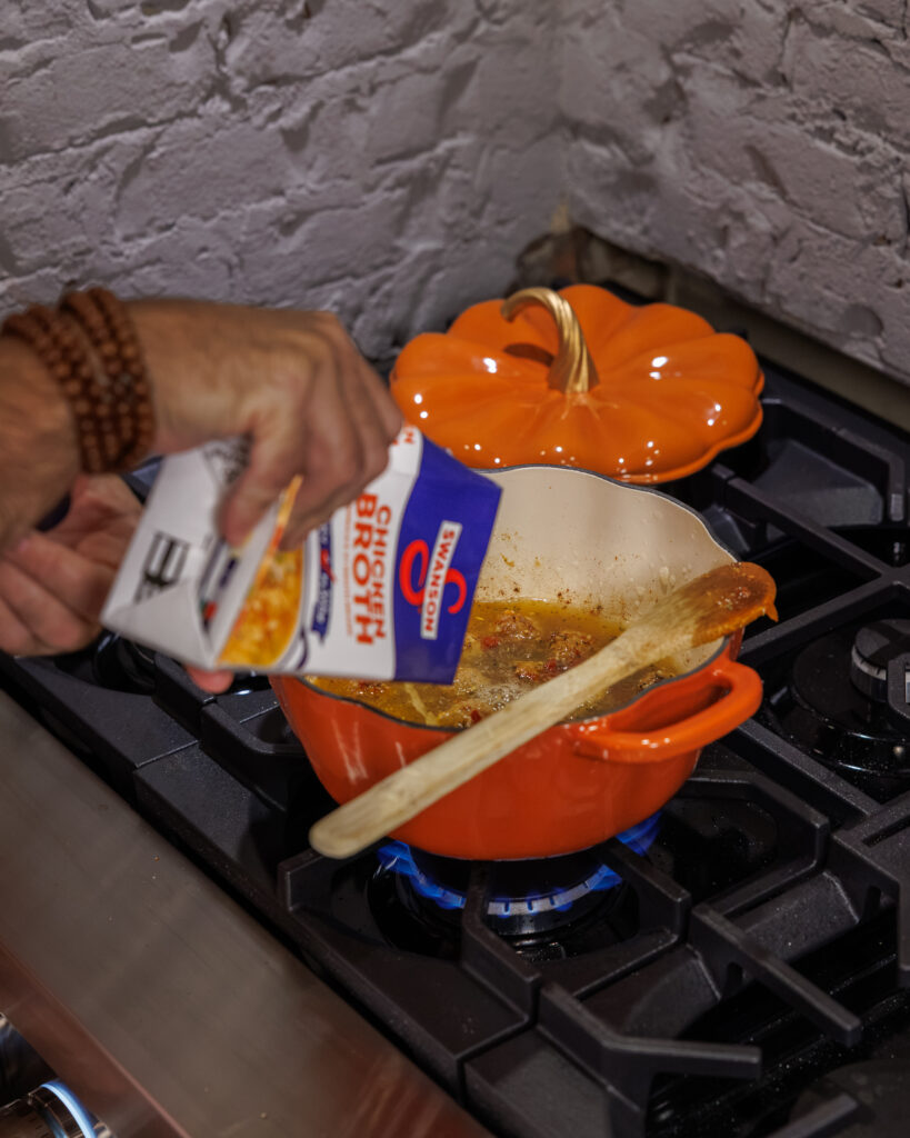 Matthew Bounds, creator of Your Barefoot Neighbor, cooks Goat Cheese Meatball Gnocchi on the stovetop in a pumpkin pot