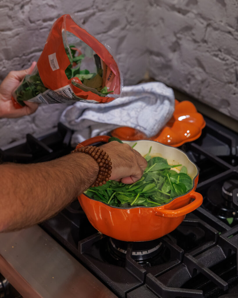 Matthew Bounds, creator of Your Barefoot Neighbor, cooks Goat Cheese Meatball Gnocchi on the stovetop in a pumpkin pot