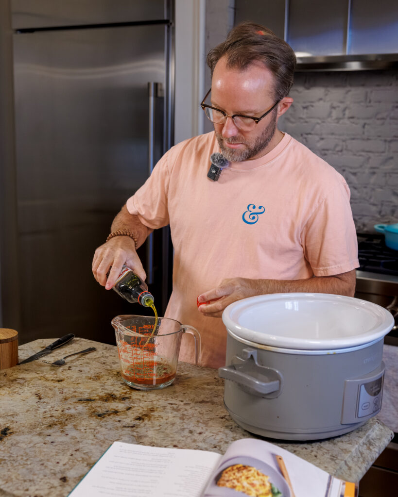Matthew Bounds, creator of Your Barefoot Neighbor, adds ingredients to the Crockpot for his Lemon Sun Dried Tomato Chicken