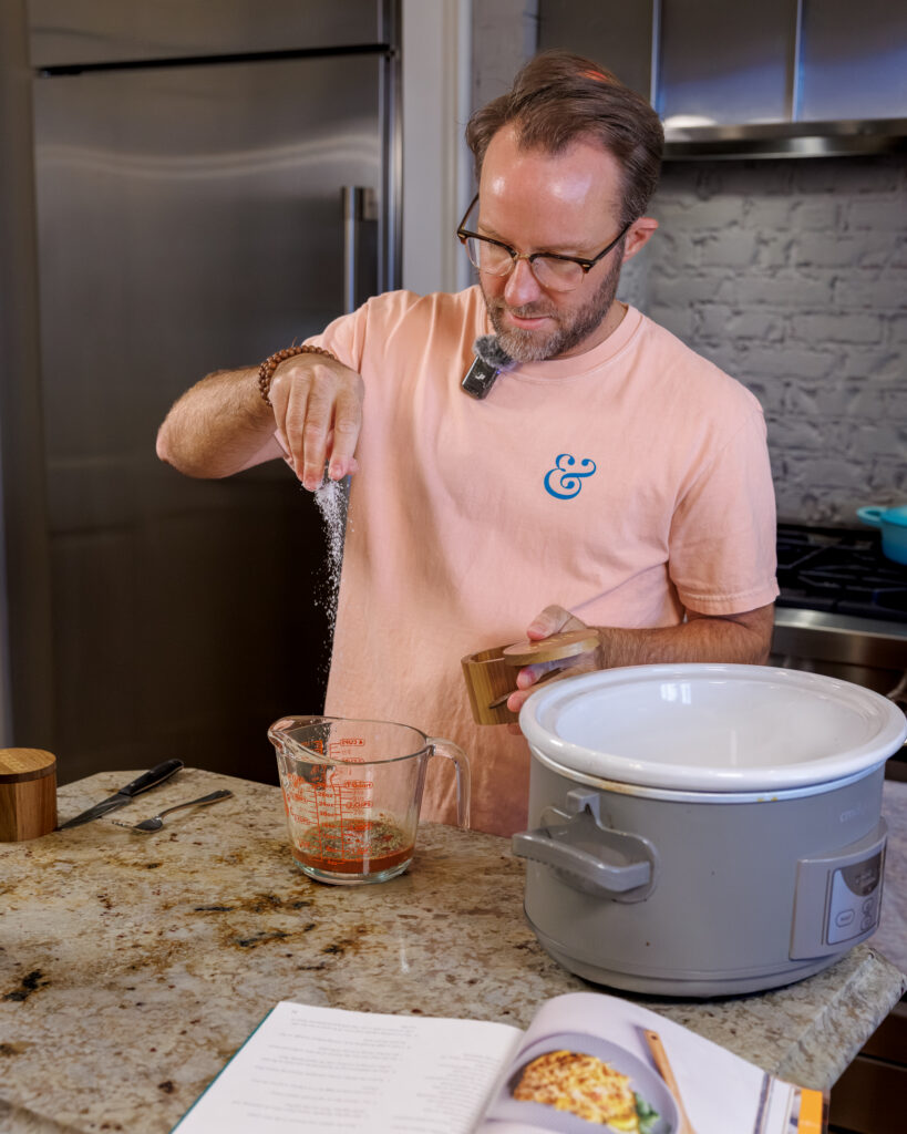 Matthew Bounds, creator of Your Barefoot Neighbor, adds ingredients to the Crockpot for his Lemon Sun Dried Tomato Chicken