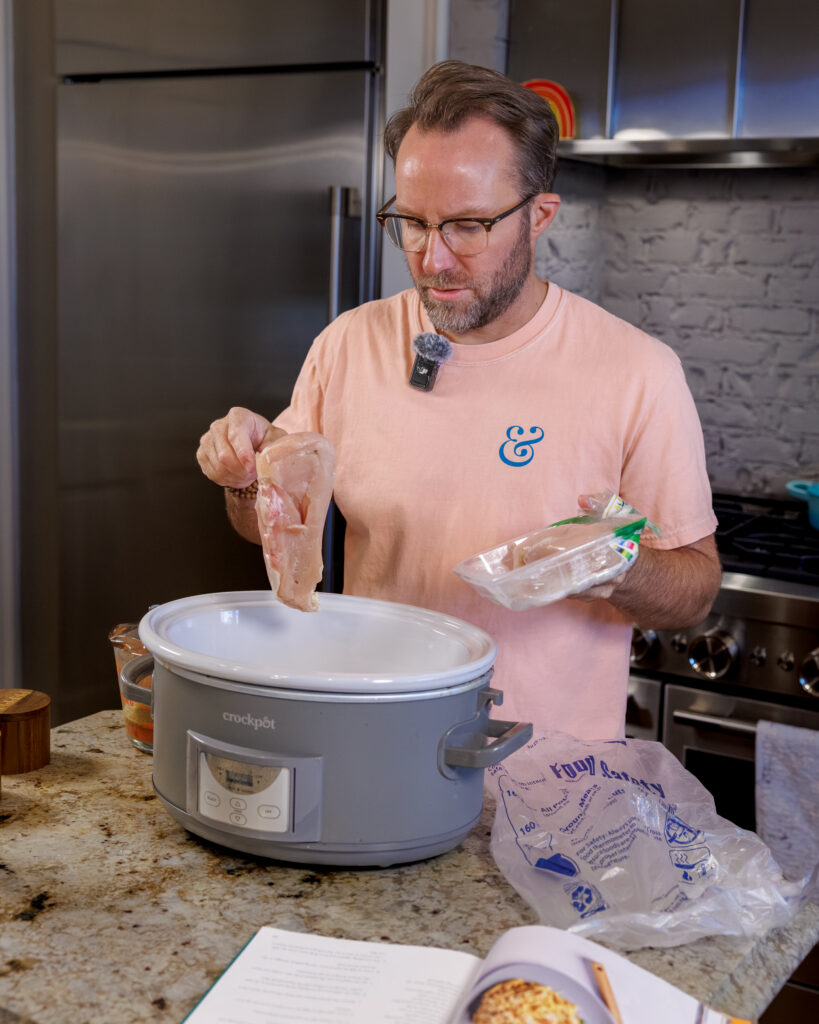 Matthew Bounds, creator of Your Barefoot Neighbor, adds ingredients to the Crockpot for his Lemon Sun Dried Tomato Chicken