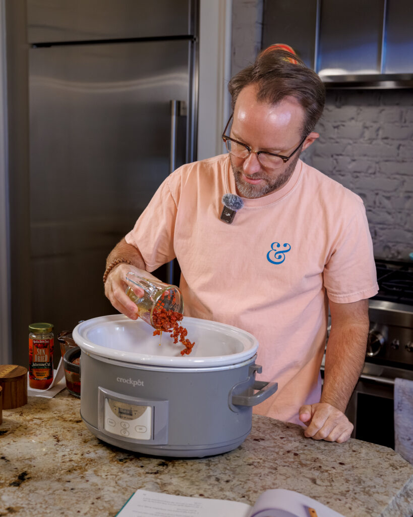 Matthew Bounds, creator of Your Barefoot Neighbor, adds ingredients to the Crockpot for his Lemon Sun Dried Tomato Chicken