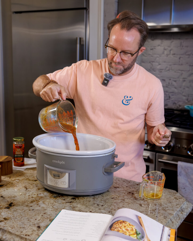 Matthew Bounds, creator of Your Barefoot Neighbor, adds ingredients to the Crockpot for his Lemon Sun Dried Tomato Chicken